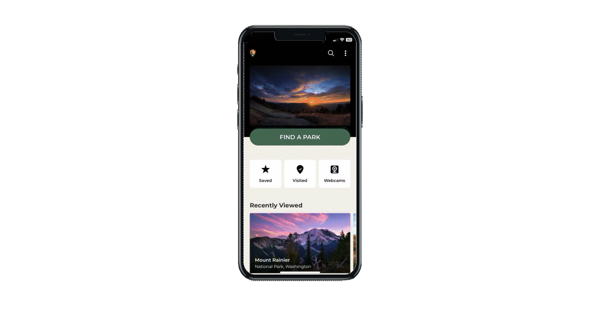 A phone with a video demo of the NPS homepage and search features playing on a loop.